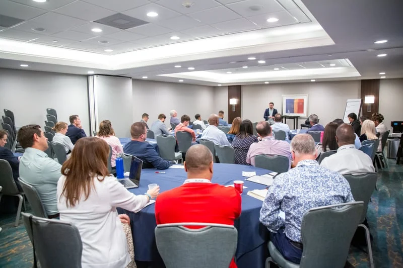 Attendees participating in a Customer Experience Conference session