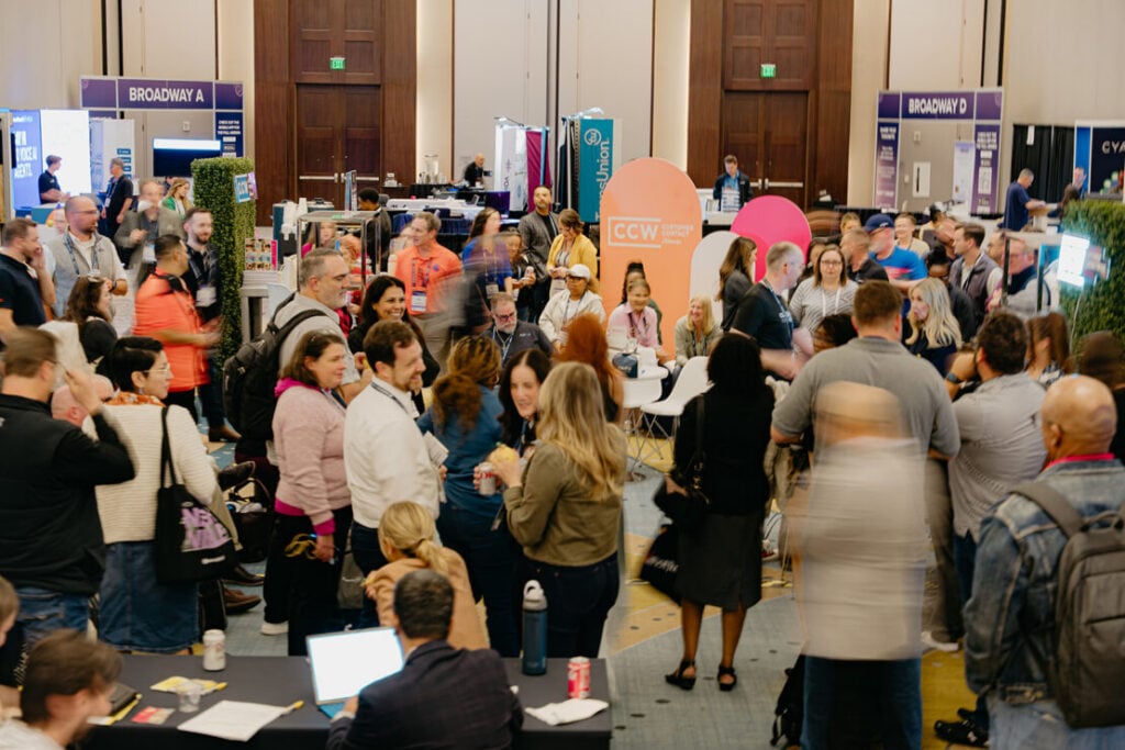 Attendees networking at the trade show floor at the Customer Contact Week conference