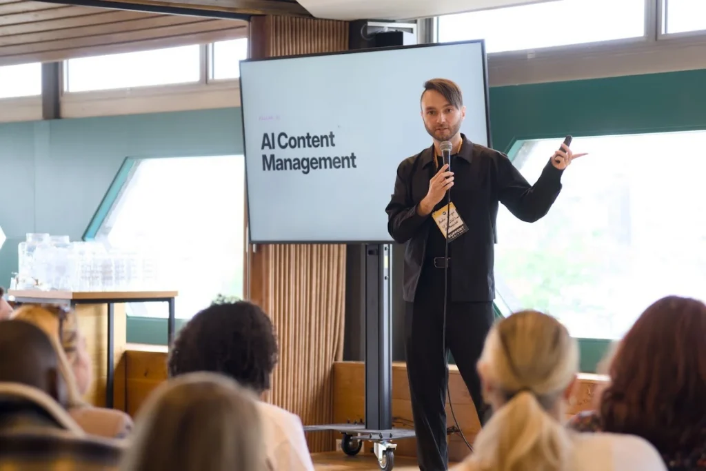 Presenter speaking about AI content management to an audience at Support Driven Expo.